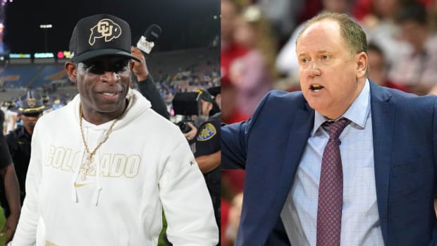 Colorado coach Deion Sanders walks off the field after a game. Wisconsin coach Greg Gard reacts to a play.